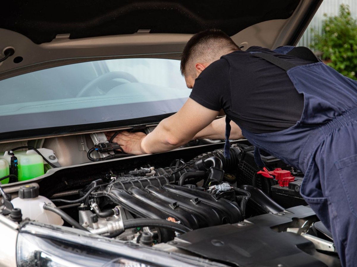 Technician working under the hood